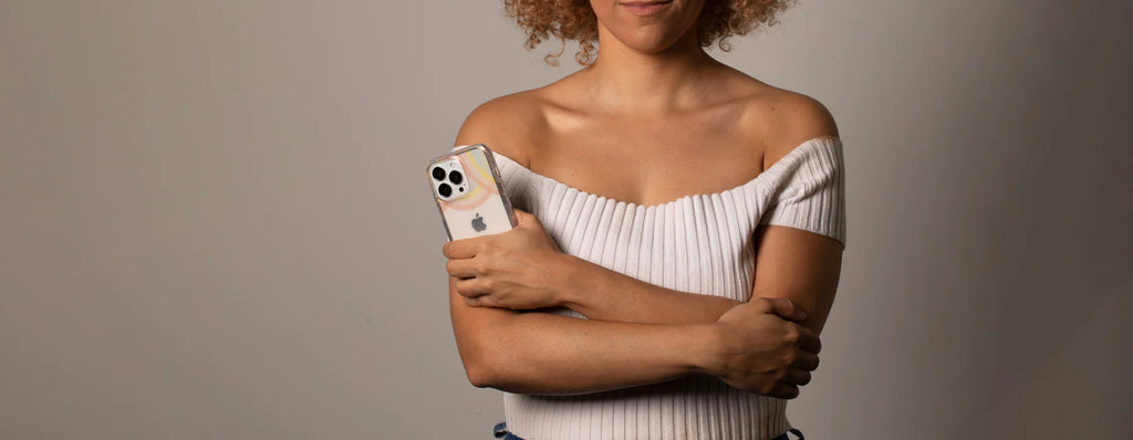 person holding incipio design series case in hand with arms crossed